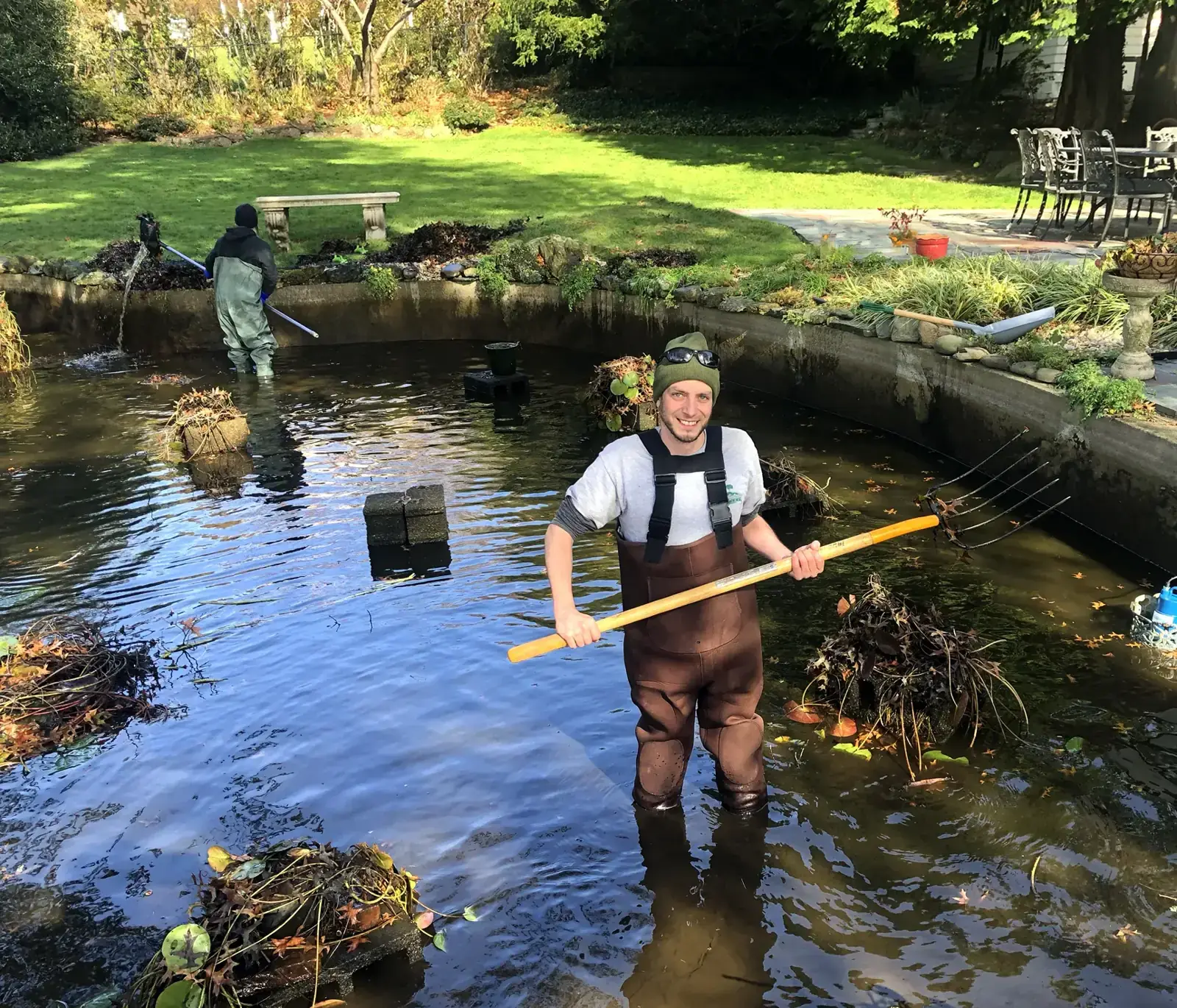 Scott Anderson Design crew in waders doing a spring pond cleanout in Halesite