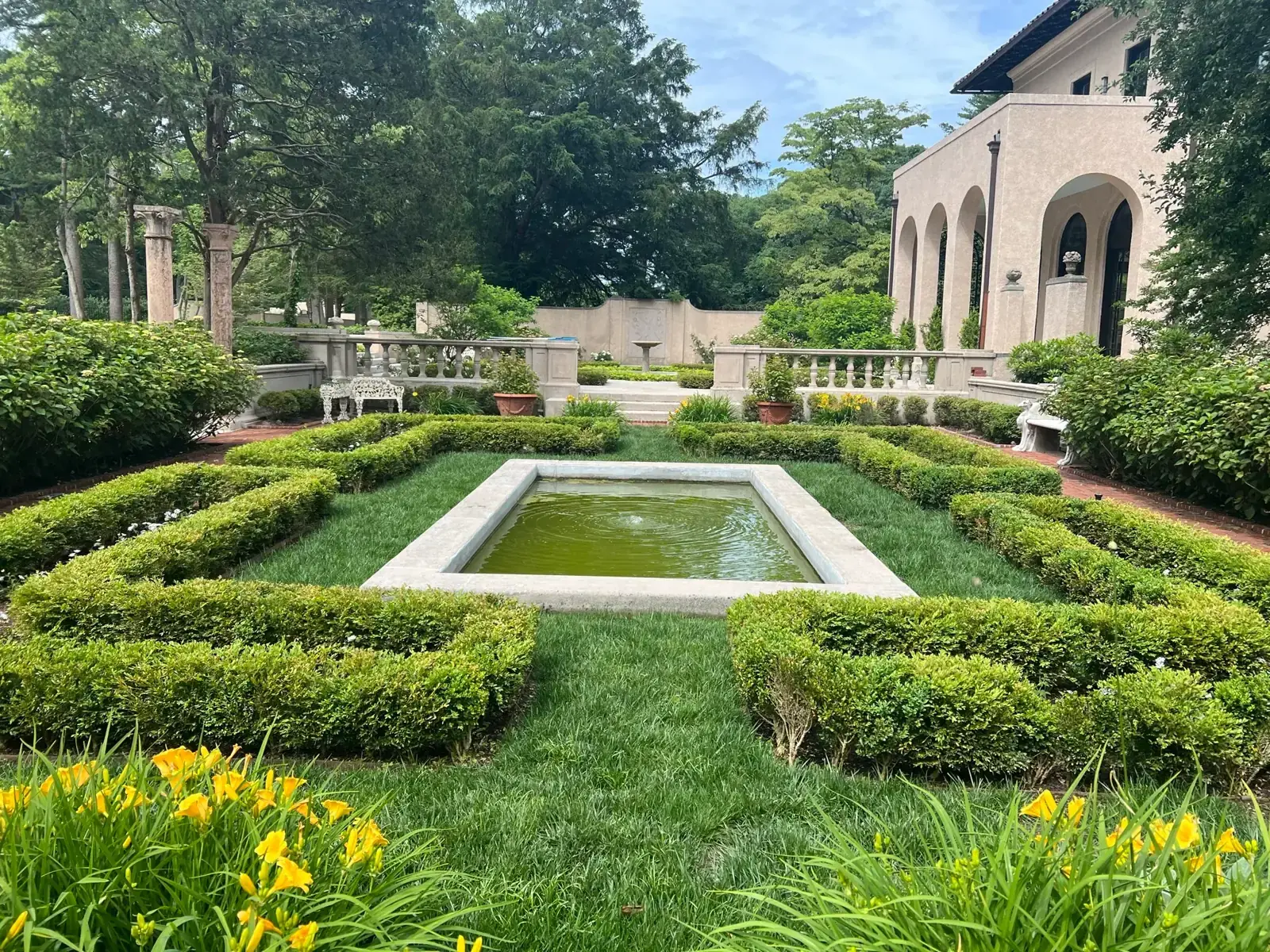 Formal garden with a reflecting pool and clipped hedging