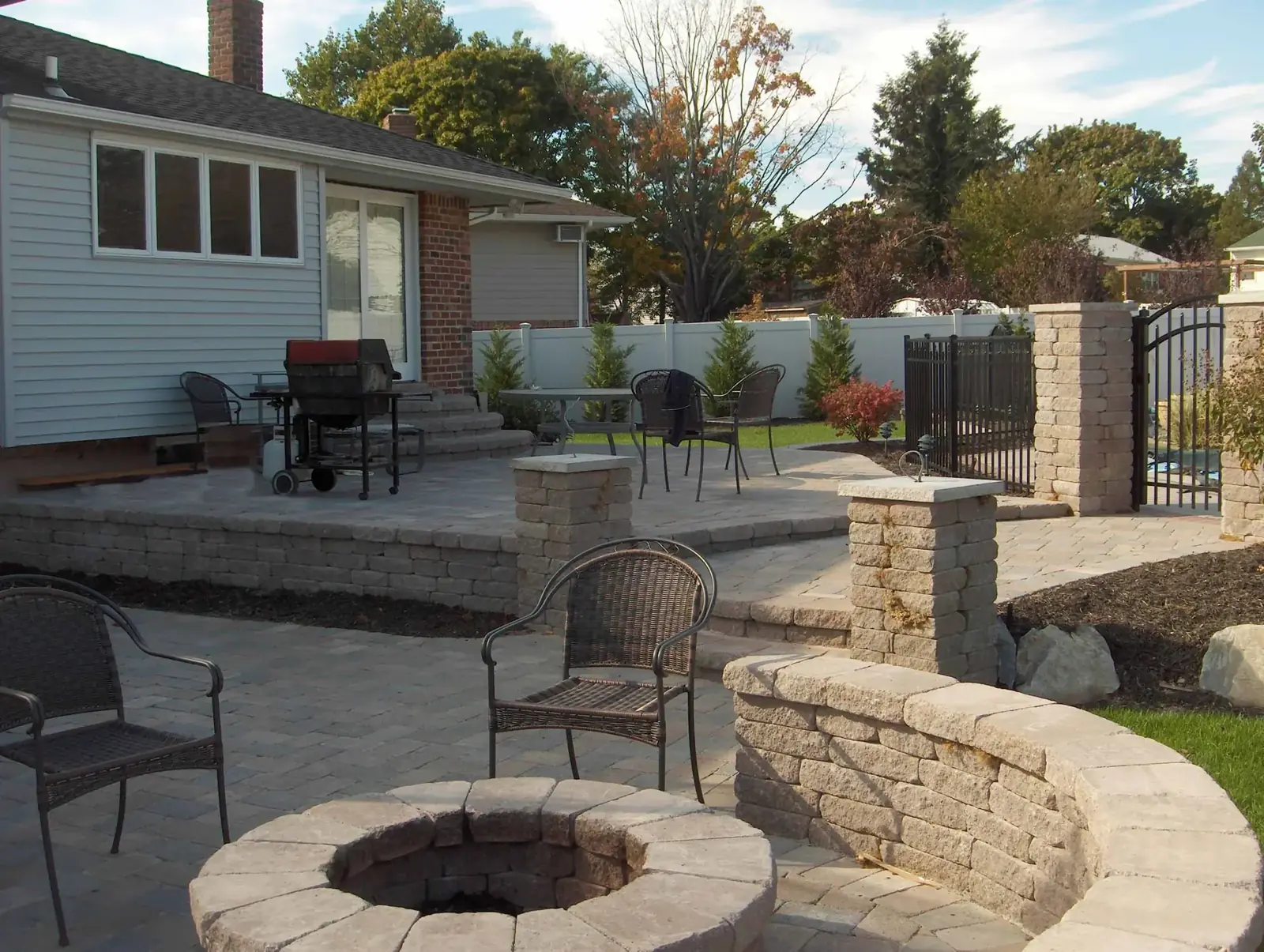 Bluestone patio with a stone firepit and seat wall