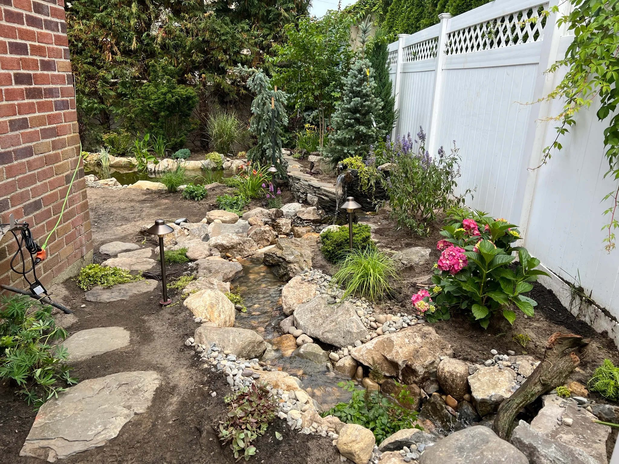 CS5 — pondless waterfall and garden plantings